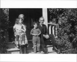 Sonoma Neil Medley sitting on the steps of her home at 231 Wilson Street, Petaluma, California with her two children and her brother, about 1924