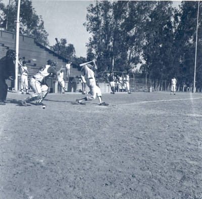 Don Rich makes a base hit during a baseball game at W. O. Hart Park, Orange, California, 1965