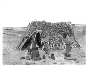 Navajo family at their hogan in Blue Canyon, ca.1900