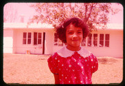 A Girl Smiling In Front Of A Camp Building