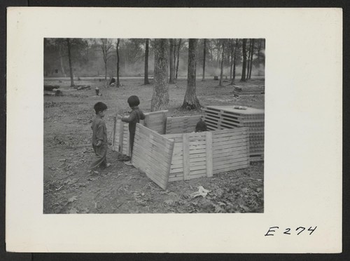 Children playing house in a makeshift play house. Photographer: Parker, Tom Denson, Arkansas