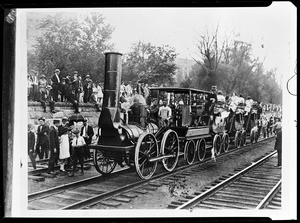 View of carriages being pulled by a small engine