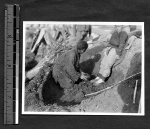 Preparing ground for building temporary shelter, Jinan, Shandong, China, 1927-1928