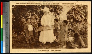 Missionary sister sitting with children in a garden, Congo, ca.1920-1940
