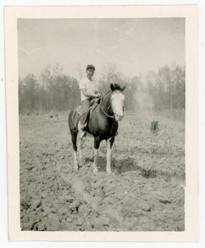 Man riding horse at incarceration camp