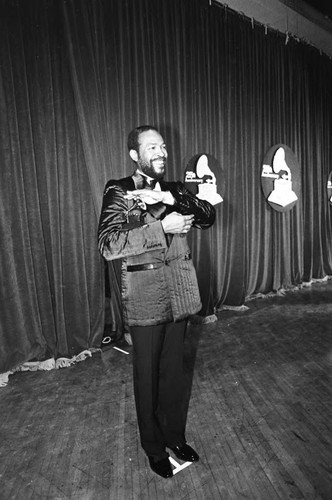 Marvin Gaye posing with his Grammys backstage at the 25th Annual Grammy Awards, Los Angeles, 1983