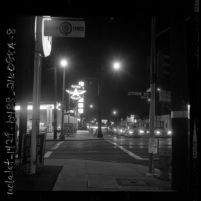 Night photograph of Flying A service station and traffic at intersection of 1800 W Jefferson Blvd and Western Ave. in Los Angeles, Calif., 1962