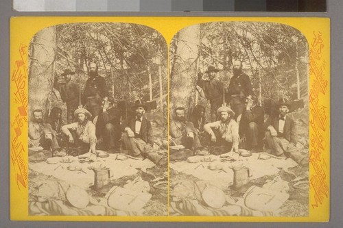 [Group of men lunching beneath tree with Native American almost occluded on left-hand side]