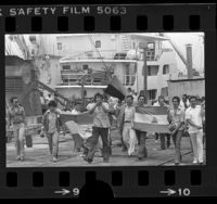 Flag carrying Sandinista sympathizers marching along dock in Terminal Island, Calif., 1979