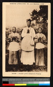 Indigenous priest flanked by acolytes, Niger, ca.1920-1940