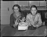 Sisters Atela and Carmen Anaza show disgust over being offered pie after they recovered from food poisoning, Los Angeles, 1936