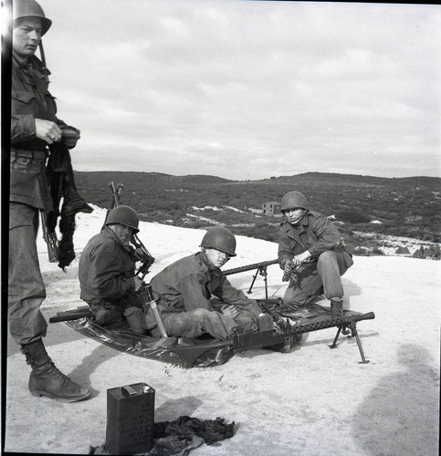 Williams and two others training on .30 caliber machine guns at Fort Ord