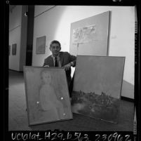 Artist John Paul Jones, displaying three of the paintings from his exhibit at Los Angeles County Museum of Art, 1965