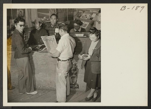 A view of the magazine and newspaper stand in the community store. George Yamashita is the manager of this newsstand. Photographer: Stewart, Francis Manzanar, California