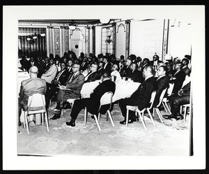 Audience around tables at an unidentified COGIC conference