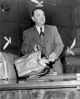 [Edmund G. Brown unpacking his brief case in his new offices at the State Building here]