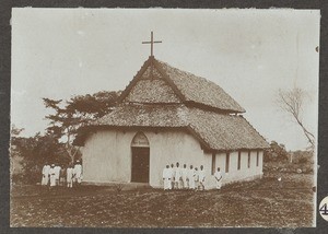 People next to a thatched church, Tanzania, ca.1900-1913