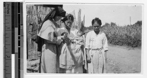 Sister Margaret, MM, admiring twins, Gishu, Korea, December 1931