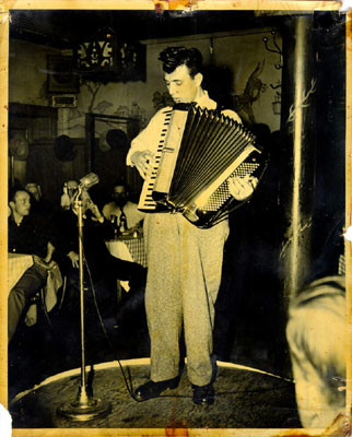 [Unidentified man playing the accordion restaurant in North Beach]