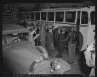 Japanese nationals board bus for evacuation and relocation, California, 1942