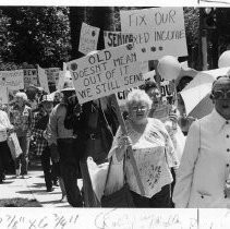 Older demonstrators march at the California State Capitol to protest cuts in state and federal social programs