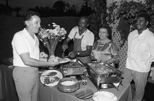 Elbert T. Hudson standing at a buffet table, Los Angeles, 1984