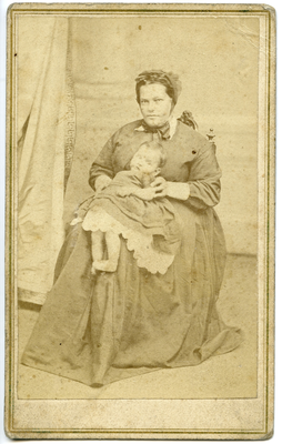 Portrait of unidentified woman holding child