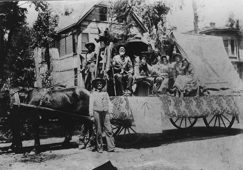 Grandpa Holcomb on decorated parade wagon [graphic]