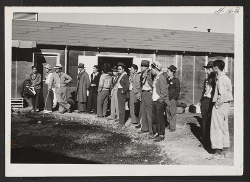 Group of Hawaiian transferees at Topaz waiting for bus to convey them to Delta Station. Topaz, Utah
