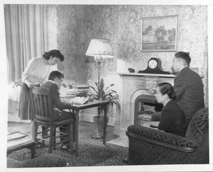 "They're Japanese--but loyal Americans. Here is another typically American scene in the home of a loyal Japanese-American family"--caption on photograph