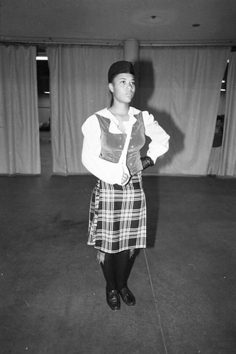 Granada Hills High School student posing with her arm in a sling at a drill team championship, Los Angeles, 1983