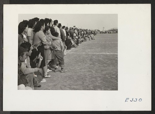 A crowd of evacuees watching a football game between teams representing Stockton and Santa Anita Assembly Centers. Photographer: Parker, Tom McGehee, Arkansas
