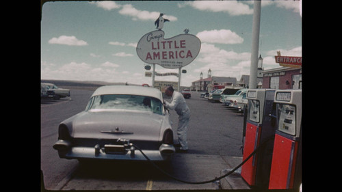 Maynard Parker Home Movie: April 2 - May 10, 1961. Maynard Parker's wisteria colored Lincoln Premiere, filling up at Covey's Little America, Granger, Wyoming. Reel2_02.09.26.03