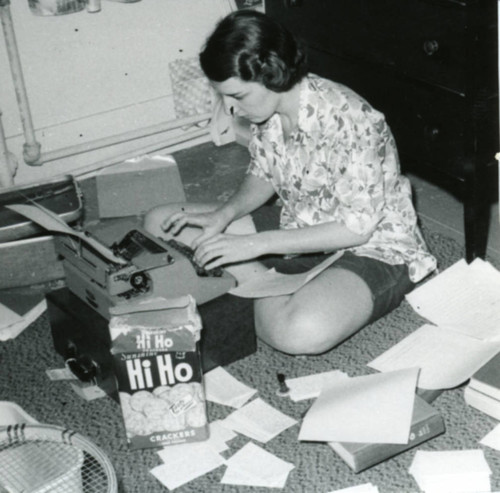 Woman using a typewriter, dormitory room, Pomona College
