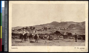 Indigenous women pose on horseback with a village behind them, Lesotho, ca.1900-1930