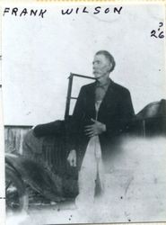 Frank Wilson standing beside a car, about 1926