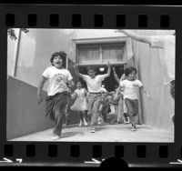 Second graders running out of door on last day of school at Dayton Heights Elementary School in Los Angeles, Calif., 1973