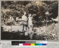 Mr. and Mrs. J. S. Black of "Treehaven" Ranch, Franz Valley near Calistoga, in their garden in 1944. The Douglas fir trees in the background were planted about 25 years ago as wildlings. Mr. Black planted about 8,000 Douglas firs on eroded vineyard land between 1939 and 1944 using nursery stock from Oregon State Nursery. Negative enlarged from Kodachrome slide. Metcalf 1944