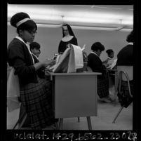 African American nun instructing girls in typing class at Regina Caeli High School in Compton, Calif., 1965