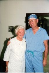 Martha Helwig, wife of Al Helwig, founder of Palm Drive Hospital with Dr John Carollo in surgery scrubs