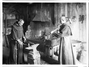 Two monks working in the blacksmith shop at Mission Santa Barbara, ca.1900
