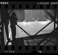 Photographer taking picture of Summa Corp engineer, George Bromley, standing on wing of the Spruce Goose airplane, 1980