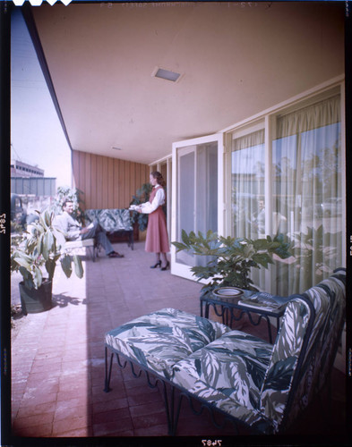[Unidentified residential exteriors and landscaping]. Man, woman and Outdoor living space