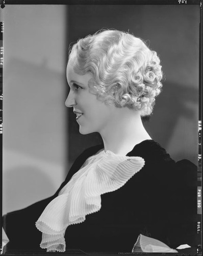Peggy Hamilton modeling an Adrian gown and a Weaver Jackson hairstyle, 1933