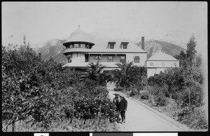 Two young boys in the garden in front of the Andrew McNally residence in Altadena, 1900