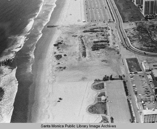 Looking north from the remains of the Pacific Ocean Park Pier at beach parking lots and the Santa Monica Shores Apartments, April 24, 1975, 2:10 PM