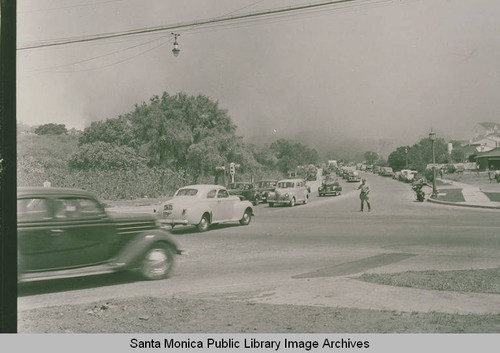 Automobiles driving away from the smoke of the 1938 fire on Sunset Blvd. in Pacific Palisades