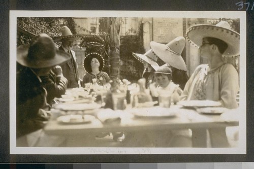 [Phelan and others wearing sombreros while dining]