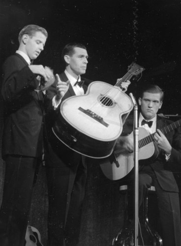 Three Musicians Playing Guitars