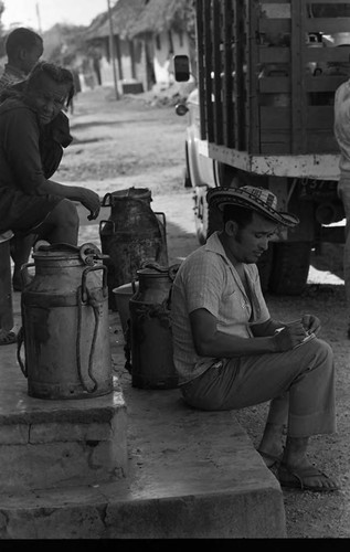 Man trading milk, San Basilio de Palenque, 1975